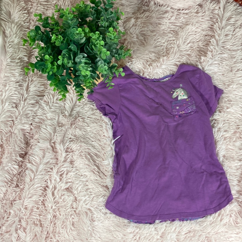 Girls purple size 8 t-shirt with unicorn pocket and galactic fantasy back.